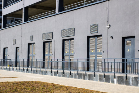 A striking contemporary exterior that showcases distinctive door designs alongside industrial...