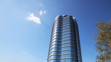 A tall and impressive building stands majestically, complemented by a vibrant blue sky that...