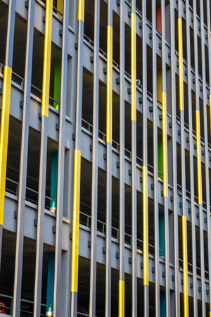 There exists a large and impressive building which is decorated with numerous bright yellow bars...