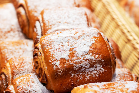 A delightful assortment of pastries, each generously sprinkled with a fine layer of powdered sugar...