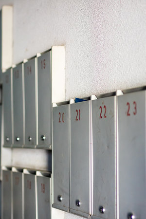 A neat row of metallic lockers displaying numbers on each of them, reflecting the shine of silver...