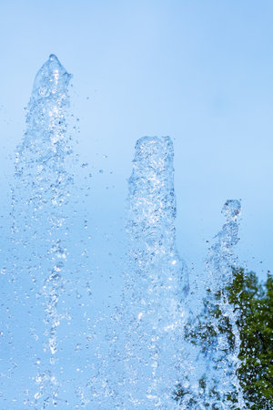 A beautiful fountain stands elegantly, with a bright blue sky serving as a stunning backdrop...