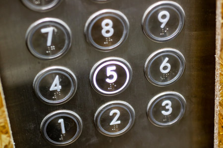 This is a detailed closeup image showing an elevator keypad, where the numbers from 1 to 9 are...
