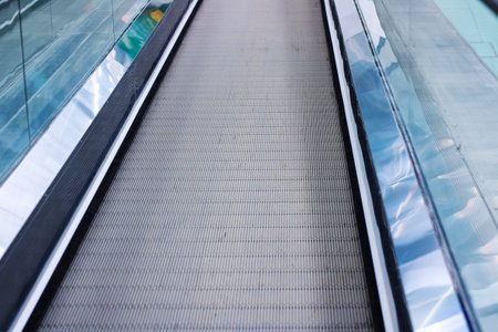 This is a closeup view of an escalator that is moving both up and down, showing its intricate design...