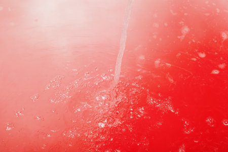 The visual features composition a vibrant red background adorned with several scattered white spots that enhance its overall appearanceの写真素材