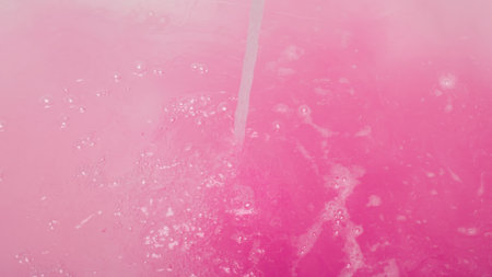 A vibrant abstract background featuring pink fluid textures and bubbles, perfect for creative projects and artistic designs.の写真素材
