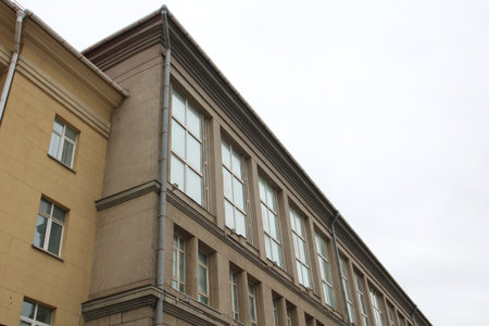 A wonderful balcony positioned on the side of a beautiful building featuring charming arched windows...