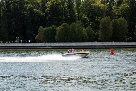 A vibrant speedboat navigates clear waters against a backdrop of lush greenery, showcasing adventure...