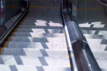 This is a detailed closeup view of an escalator that is moving both upward and downward, showing its...