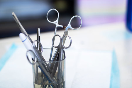 Dental instruments in metal holder arranged on sterile tray, closeup shallow depth of field, cool...