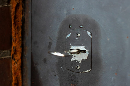 Rusty metal door with key, closeup showing weathered lock, chipped paint, corroded surface and...