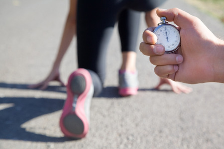 close-up of a stopwatch in hand man for measuring the running speed of the athleteの写真素材