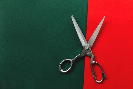 Scissors on red and green felt background.の写真素材