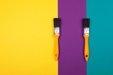 Brush with yellow handle on blue yellow purple background. Main trend concept. View from above.の写真素材