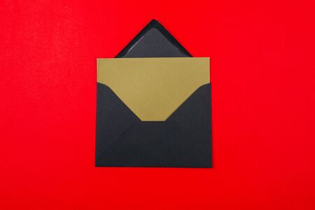 Junk mail or spam and fake letter idea. Concept for unsolicited mail or e-mail. Envelope on red backgroundの写真素材