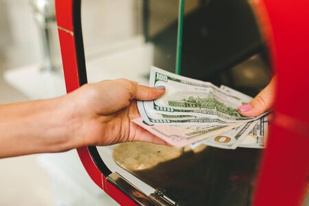 Girl changes dollars in exchange of currencies.exchange rateの写真素材