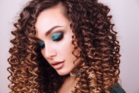 Close up portrait of elegant luxurious woman in trendy green sequin party dress . Elegant wavy hairstyle, bright make up, red nails.の写真素材