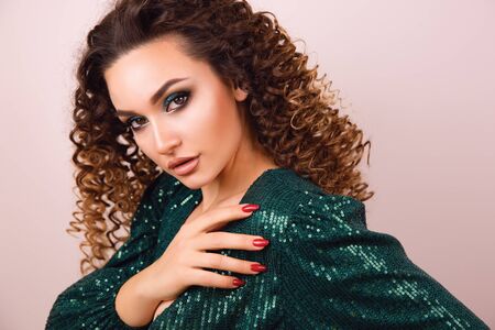 Close up portrait of elegant luxurious woman in trendy green sequin party dress . Elegant wavy...