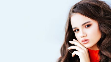 Young teenager on light background. Looking at camera with joyful and charming smile. Amazing teen woman posing at street at autumn outfit, jeans, glam style,teen hipster trend outfit, mood, modelの写真素材