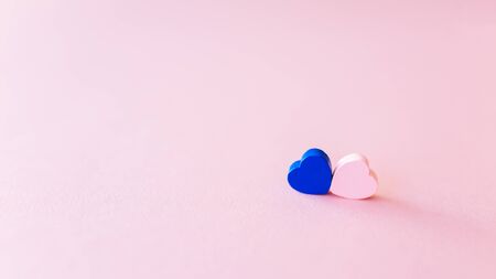 Two wooden hearts on a rose delicate background, blue and pink, Valentines Day concept, close-upの写真素材