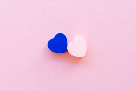 Two wooden hearts on a rose delicate background, blue and pink, Valentine's Day concept, close-upの写真素材