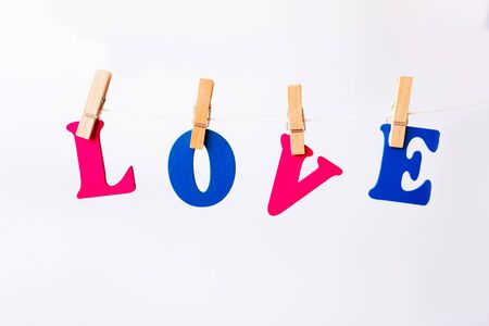 Clothes pegs and I LOVE YOU words on papers on rope on white background Valentines day conceptの写真素材