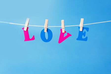 Clothes pegs and I LOVE YOU words on papers on rope on white background Valentines day conceptの写真素材