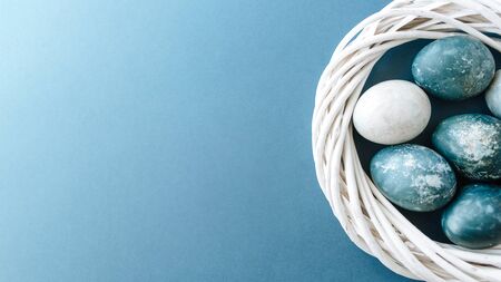 Banner of Group ight blue eggs in their nest on a blue background. Happy Easter decoration