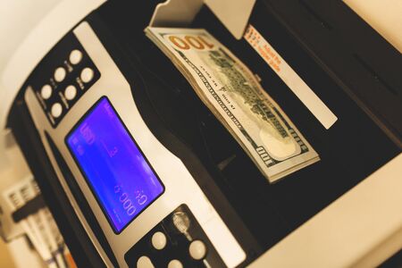 Machine for counting money and 100 dollar billsの写真素材