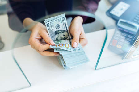 Woman counting money banknotes.Concept photo of money, banking ,currency and foreign exchange rates.の写真素材