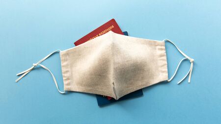 Coronavirus and travel concept. Passports and medical mask flat lay.の写真素材