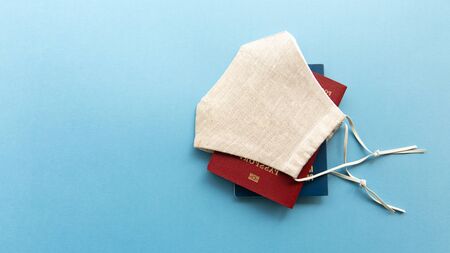 Coronavirus and travel concept. Passports and medical mask flat lay.の写真素材