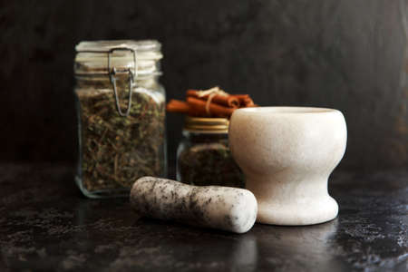 Jars of different leaf teas on dark backgroundの写真素材