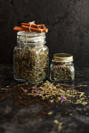 Jars of different leaf teas on dark backgroundの写真素材