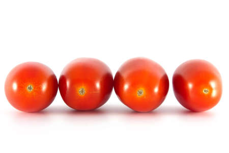 Four tomatoes on a white backgroundの写真素材