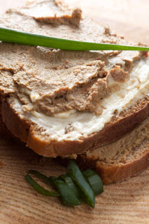 Liver pate sandwich served on crusty bread and garnished with herbsの写真素材