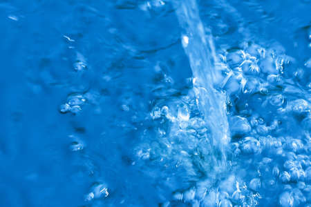 Abstract background of liquid splashing from the surface of the water with bubbles sprayingの写真素材