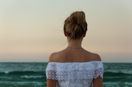 Girl looking at the sea horizon