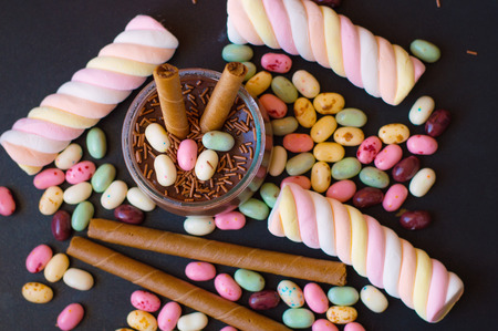 Marshmallow, jelly beans, panna cotta and chocolate wafersの写真素材