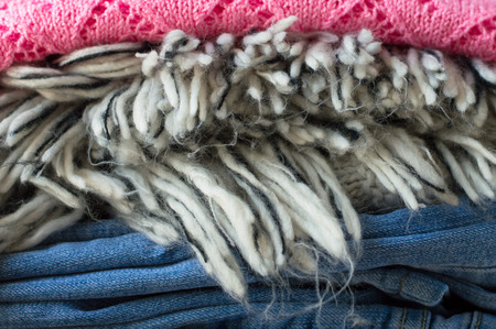 Pile of clothes: jeans, sweater and t-shirtの写真素材
