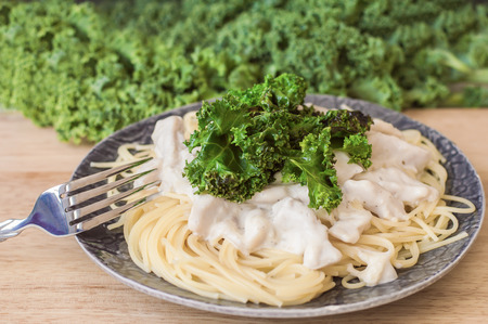 Healthy pasta with spaghetti, chicken meat in white sauce and kale. Balanced meal. Kale pastaの写真素材