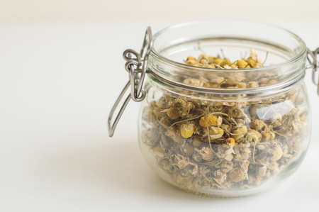 Glass jar with dried chamomile tea. Camomile flowersの写真素材
