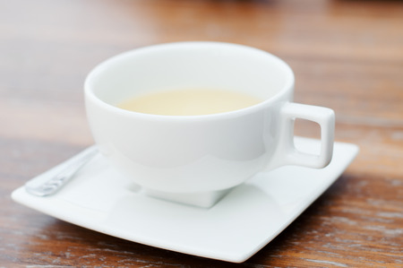 White cup of tea on wooden table. Tea drinkingの写真素材