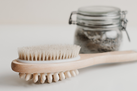 Wooden brush for body massage and a jar with scrub. Spa and body careの写真素材