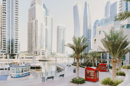 Dubai; UAE - June 6, 2020: Dubai Marina Walk early in the morning. Popular city promenade with skysrapers, cafes, restaurants, hotels, office buildings, yachts and boats cruisesのeditorial素材