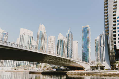 Dubai; UAE - June 6, 2020: Bridge over artificial water canal at Dubai Marina, a popular city promenadeのeditorial素材
