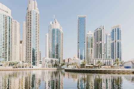 Dubai; UAE - June 6, 2020: View over Dubai Marina through artificial water canal. Residential and...