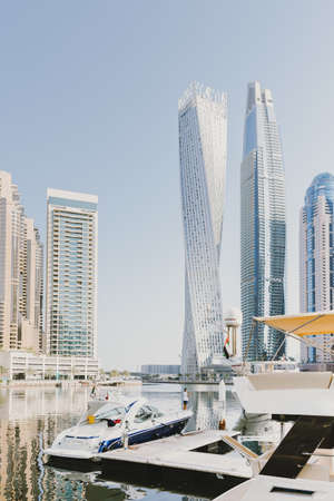 Dubai; UAE - June 6, 2020: View over Dubai Marina with tall skyscrapers and luxury yachts and boats early in the morning. Artificial water canalのeditorial素材