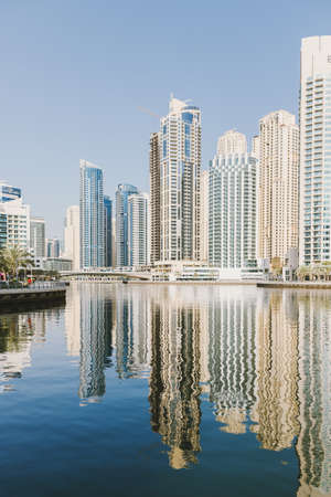 Dubai; UAE - June 6, 2020: Artificial water canal at Dubai Marina. View at Jumeirah Beach Residence buildingsのeditorial素材