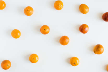 Mandarin and red oranges on white background. Fruit pattern. Healthy eating